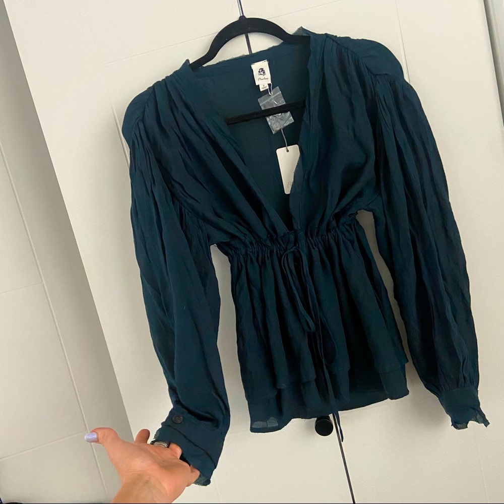 Bran new with tags, long sleeve adjustable waste draw string blouse. V neck